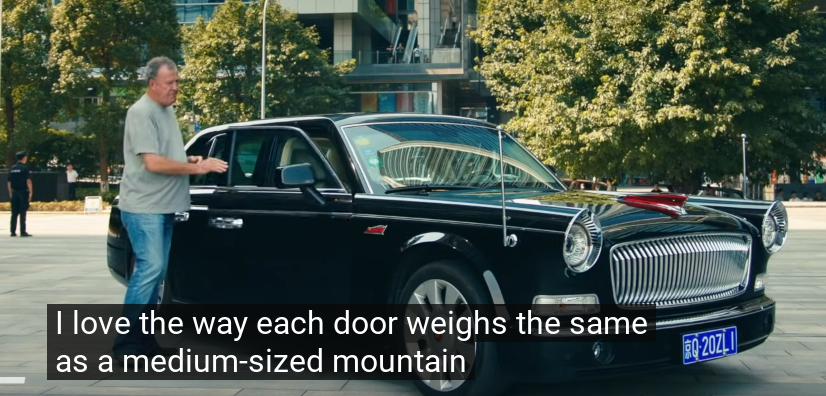 Still frame of Jeremy Clarkson commenting the door of the Hongqi limousine with 'I love the way each door weighs the same as a medium sized mountain'
