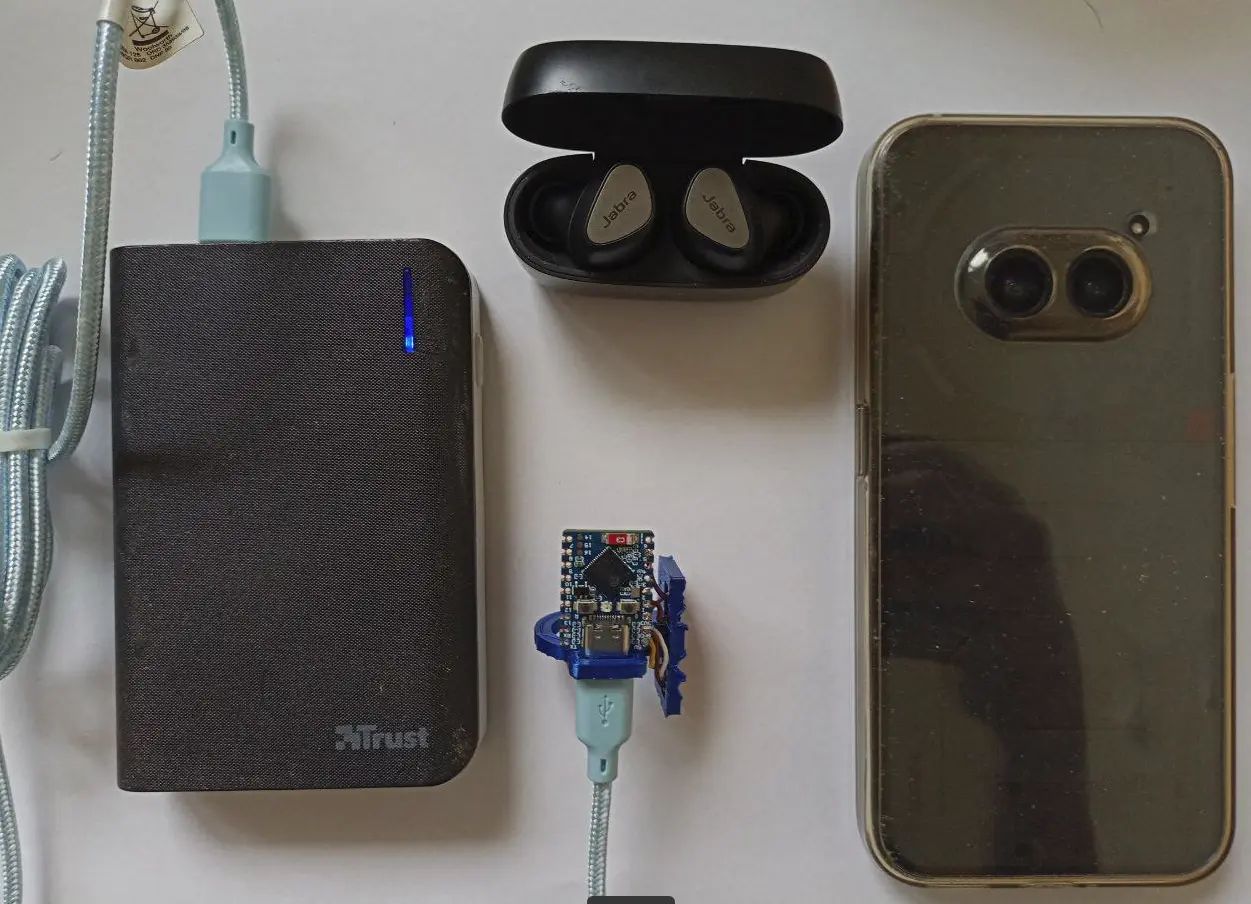 picture of a phone, headphones, the input device ring, cable and powerbank