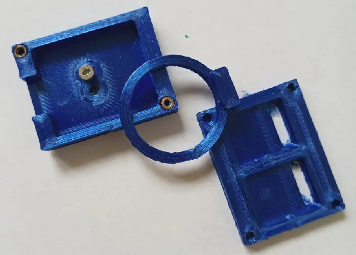 Several 3D-printed components; ring and frames for electronics, attachable with screws