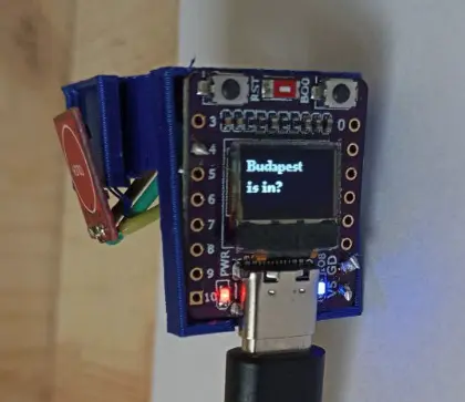 3D-printed finger ring with an attached ESP with integrated OLED screen displaying